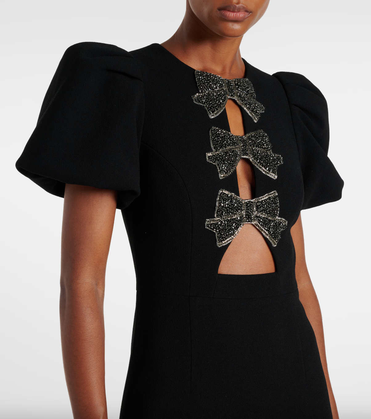 Close-up of the Rebecca Vallance Eliana midi dress's beaded bows and puffed sleeves